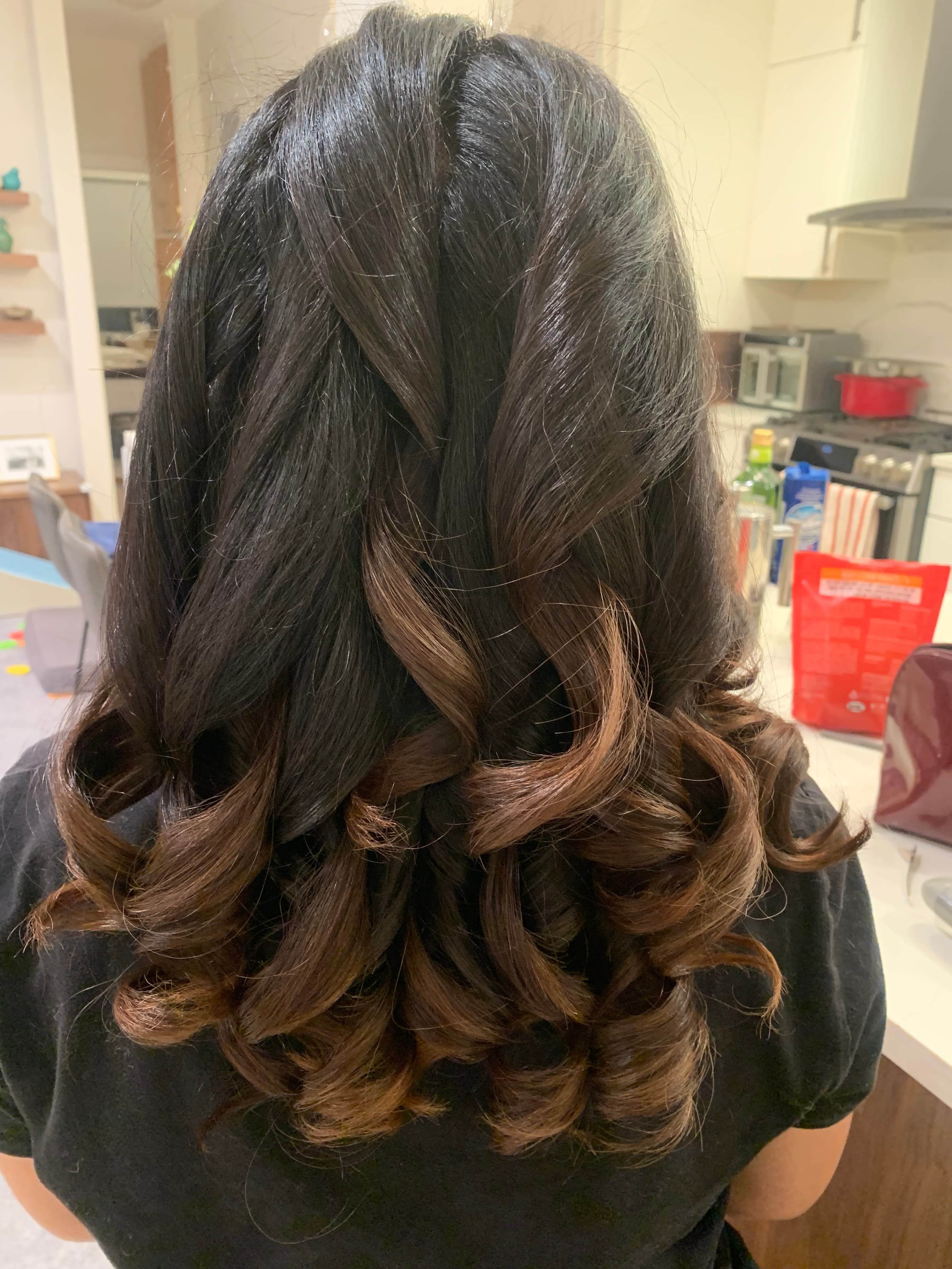 Dark hair with warm caramel color through curled ends