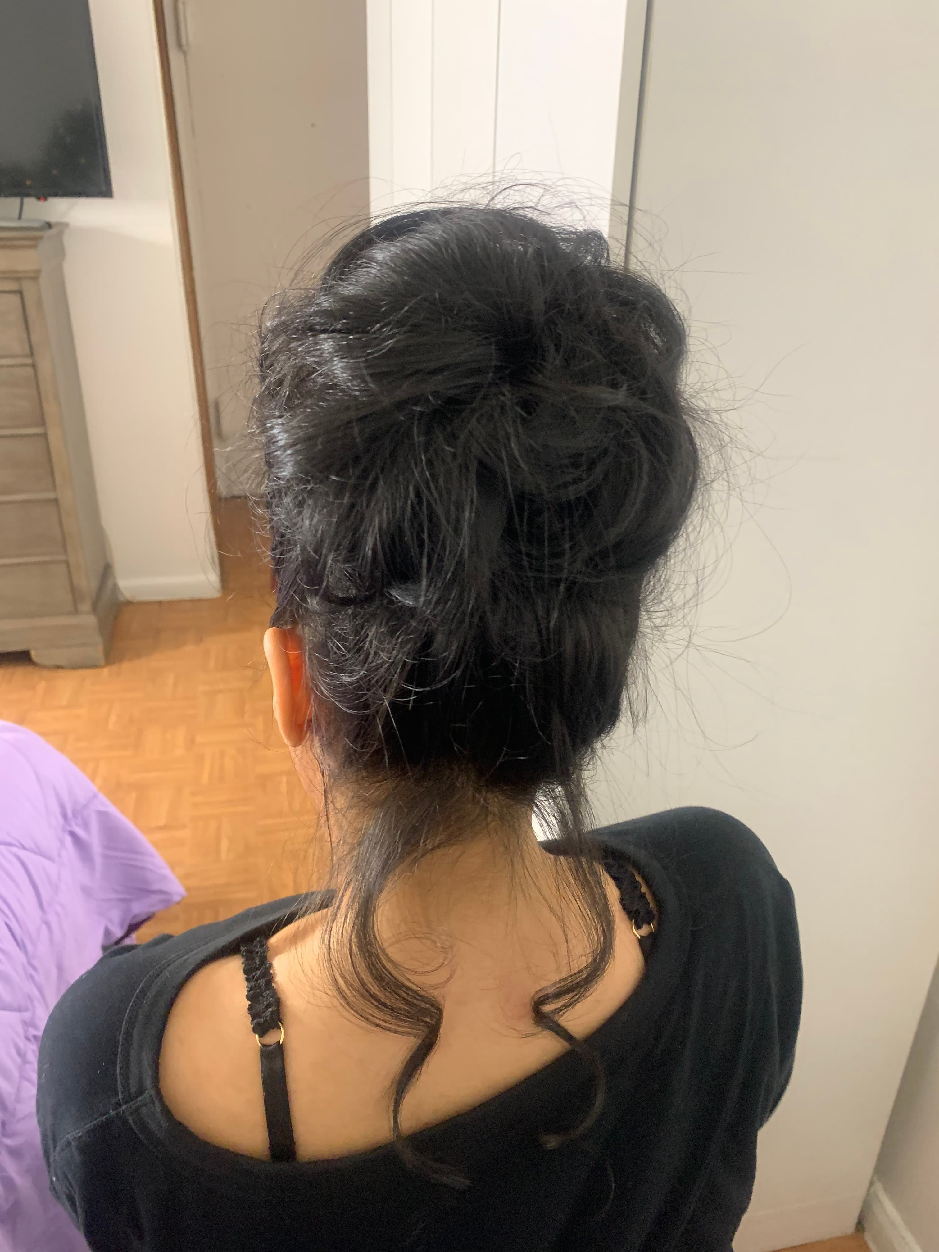 Formal updo with soft volume and curled face-framing pieces